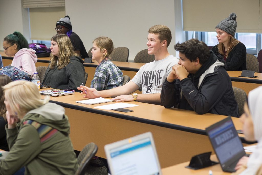 A group of students in a UBalt classroom