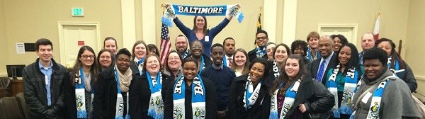 UBalt students pose in a room