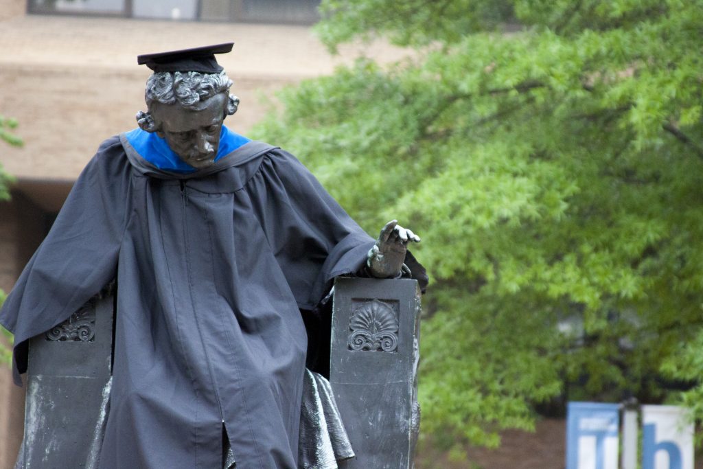 Edgar Allen Poe Statue wearing a graduation cap and gown