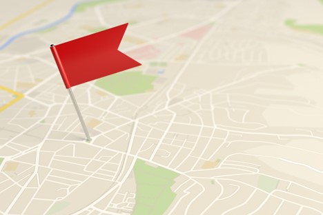 A map with a red flag pin indicating a point on the map