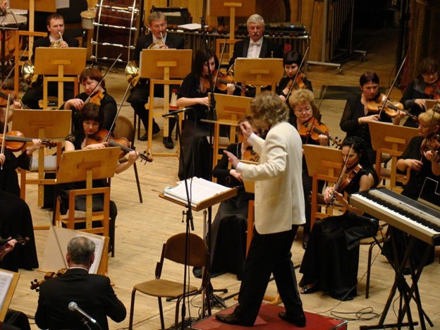 A maestro conducts the symphony orchestra
