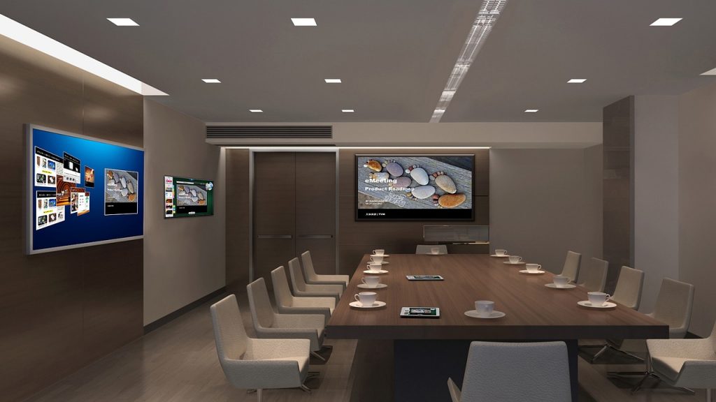 A conference room with multiple LCD screens