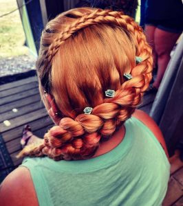 back of a woman's head, showing a thick braid